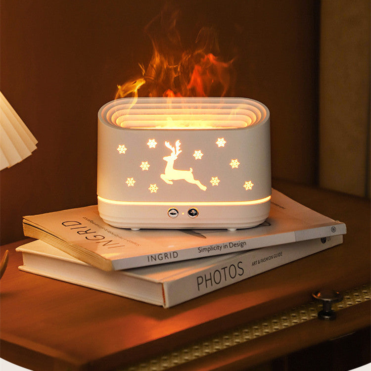 Elk Flame Humidifier & Diffuser Lamp creating a cozy flame-effect mist on a stack of books.